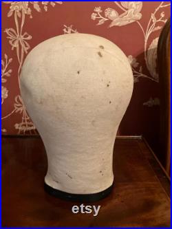A cloth mannequin head, vintage, hat headdress wig stand, plastic base, table top.