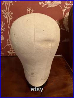 A cloth mannequin head, vintage, hat headdress wig stand, plastic base, table top.