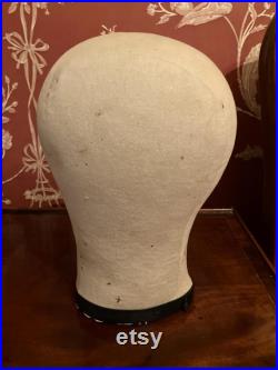 A cloth mannequin head, vintage, hat headdress wig stand, plastic base, table top.