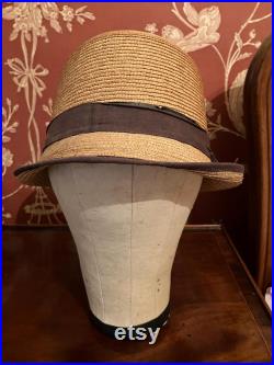 A cloth mannequin head, vintage, hat headdress wig stand, plastic base, table top.