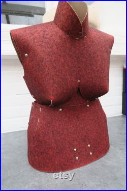 Old sewing mannequin in cardboard and red felt