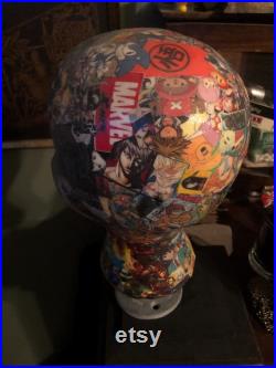 Showcase handcrafted display heads featuring decoupage and epoxy finishes, set upon a black wooden base