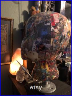 Showcase handcrafted display heads featuring decoupage and epoxy finishes, set upon a black wooden base