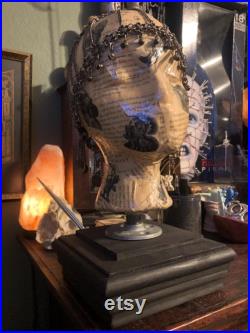 Showcase handcrafted display heads featuring decoupage and epoxy finishes, set upon a black wooden base
